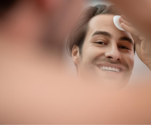 handsome-man-cleansing-his-face-with-a-sponge-2024-10-16-17-31-02-utc